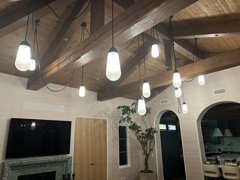 Pendant lights installed beneath an exposed wood ceiling