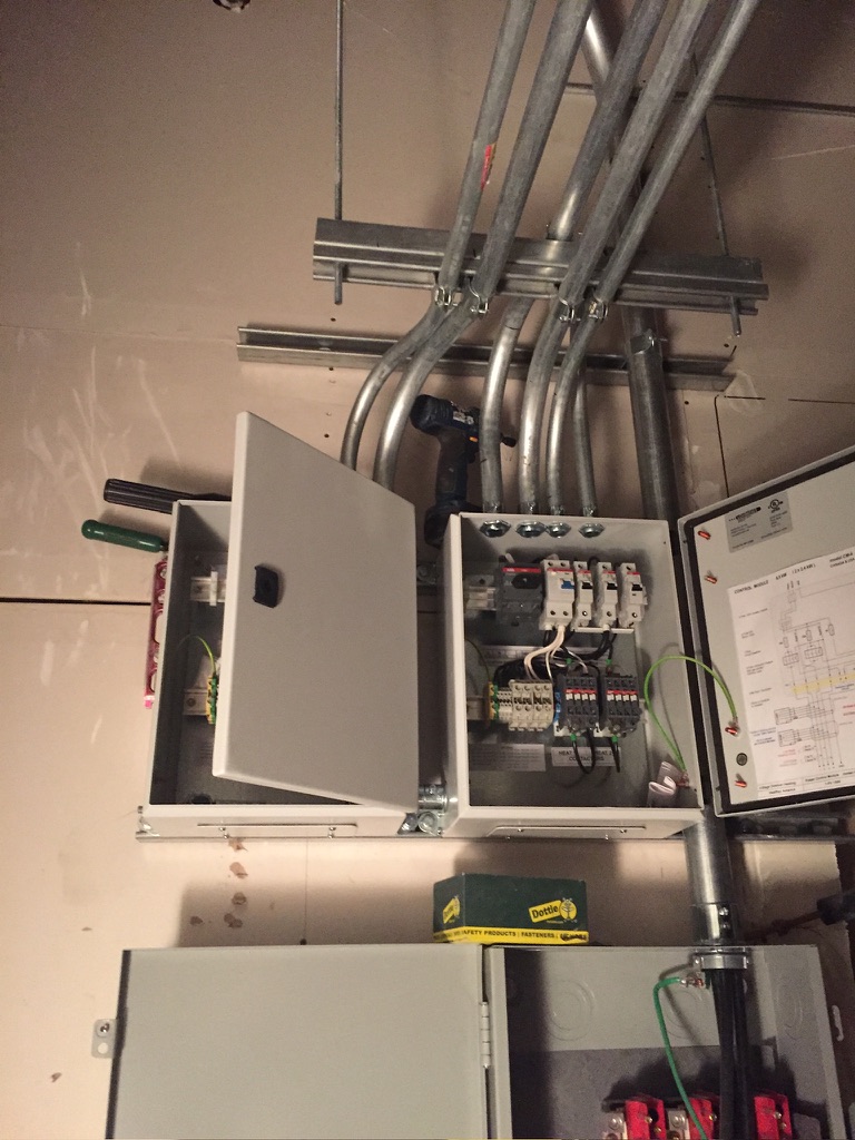 Electrical panel and conduit installation in a utility area