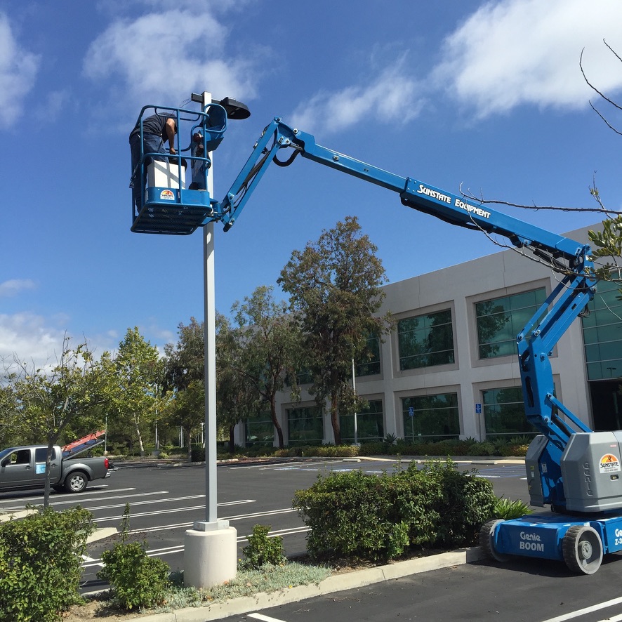 Bucket lift positioned at a parking-lot light pole