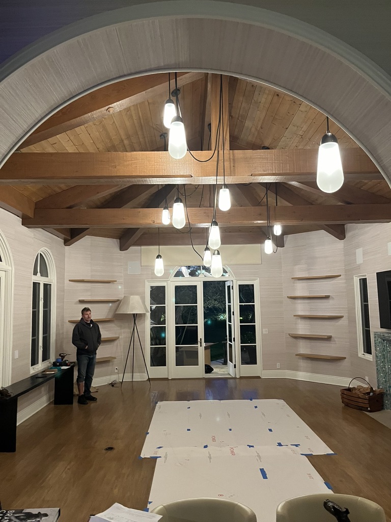 Finished interior with exposed wood ceiling and pendant lighting