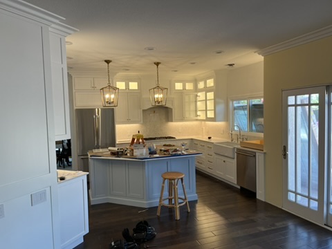 Open kitchen with layered ceiling and pendant lighting